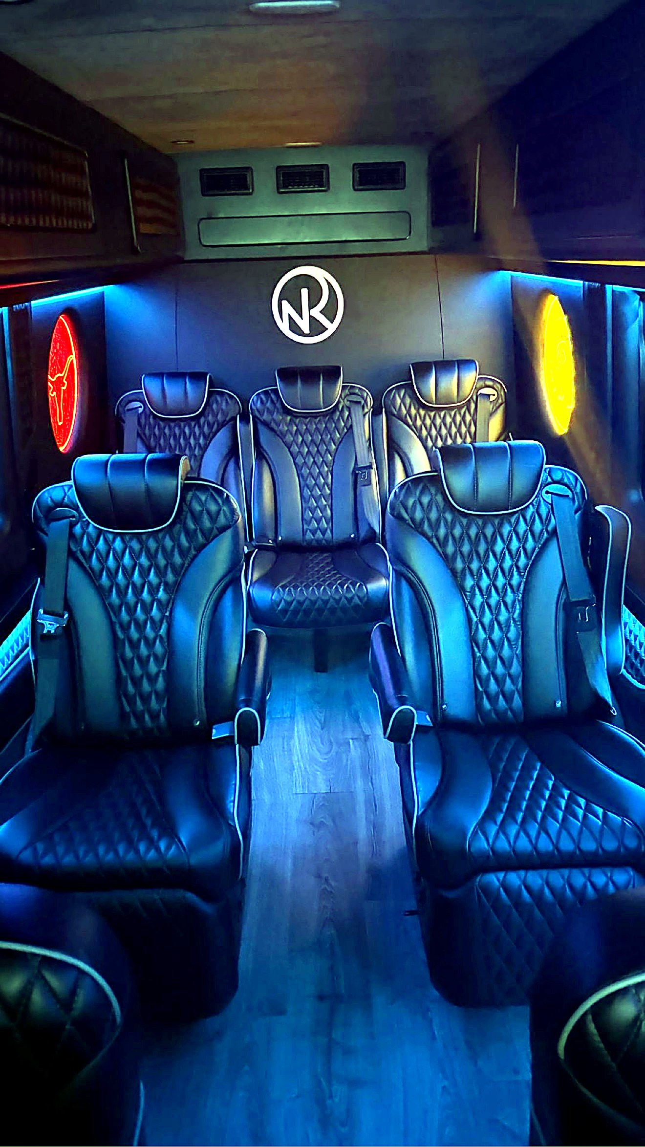 Inside the ExecSprinters Jet Sprinter — diamond-stitched captain chairs under ambient LED lighting