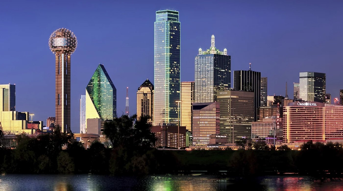 The downtown Dallas skyline at dusk with Reunion Tower, seen across the Trinity River